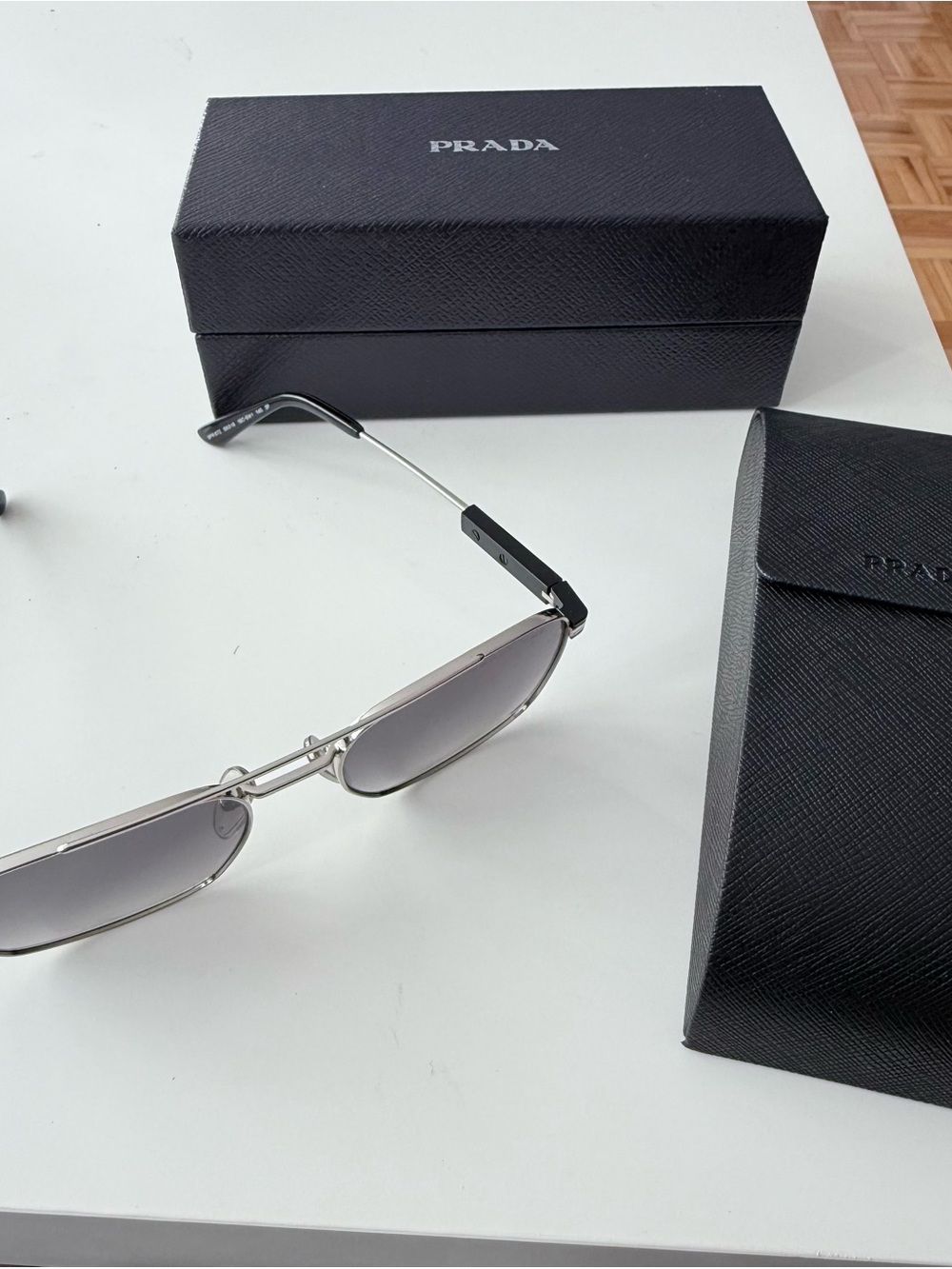 Prada Silver Frame Sunglasses with Gray Lenses